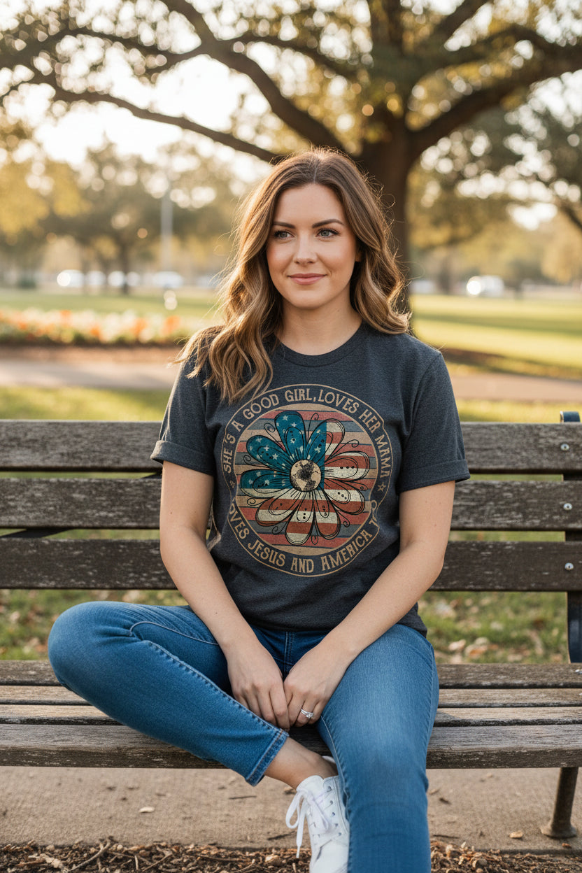 Dark gray t-shirt with a graphic design and text, paired with jeans and shoes on a white background